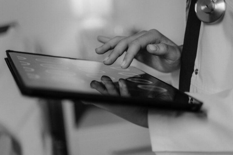 close up image of a tablet in the hands of a medical professional